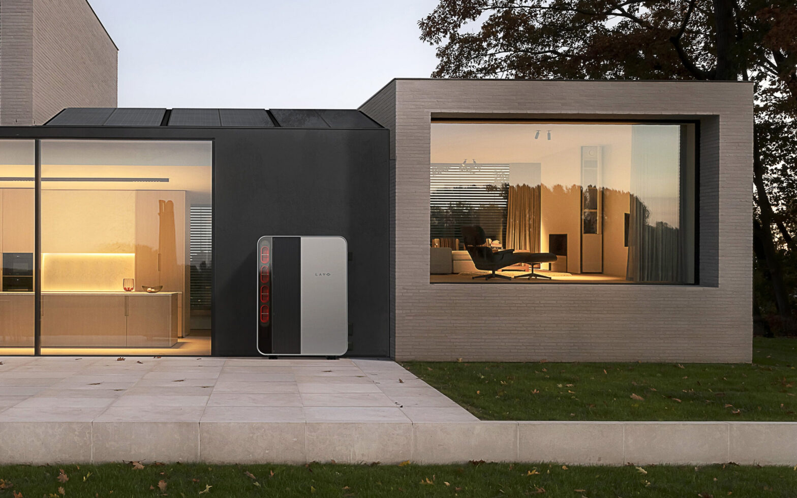 Modern residential house with solar panels on the roof and an outdoor energy storage system beside the wall.